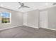 This neutral bedroom has carpet, white trim, and a ceiling fan for added comfort at 15060 Book Club Rd, Winter Garden, FL 34787