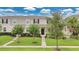 Charming townhome featuring well-manicured lawn, lush landscaping, and inviting entryway at 15060 Book Club Rd, Winter Garden, FL 34787