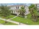 Charming townhome featuring well-manicured lawn, lush landscaping, and inviting entryway at 15060 Book Club Rd, Winter Garden, FL 34787