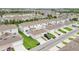 A neighborhood of townhomes features attached garages, and well-maintained lawns at 15060 Book Club Rd, Winter Garden, FL 34787