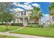 Charming home with lush landscaping, healthy lawn, and a welcoming walkway to the front door at 15060 Book Club Rd, Winter Garden, FL 34787