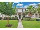 Charming home with lush landscaping, healthy lawn, and a welcoming walkway to the front door at 15060 Book Club Rd, Winter Garden, FL 34787