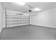 Spacious garage with an automatic door, concrete floor, and overhead lighting, providing ample parking and storage at 15060 Book Club Rd, Winter Garden, FL 34787