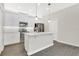 Modern kitchen with stainless steel appliances, white cabinetry, and a center island with quartz countertops at 15060 Book Club Rd, Winter Garden, FL 34787