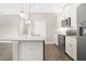 Modern kitchen with stainless steel appliances, white cabinetry, and a center island with quartz countertops at 15060 Book Club Rd, Winter Garden, FL 34787