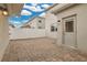 Private brick-paved patio with an entry door, surrounded by a white fence, perfect for outdoor relaxation at 15060 Book Club Rd, Winter Garden, FL 34787