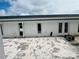 Backyard featuring a white exterior wall with three doors and paver stones at 15345 Burgtheater Dr, Winter Garden, FL 34787