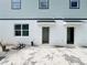 Backyard featuring a grey wall with white trim and three exterior doors at 15345 Burgtheater Dr, Winter Garden, FL 34787