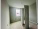 Small bedroom featuring one window and a bi-fold door closet at 15345 Burgtheater Dr, Winter Garden, FL 34787