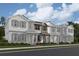 New townhomes feature neutral siding, dark shutters, covered porches, and manicured landscaping at 15345 Burgtheater Dr, Winter Garden, FL 34787