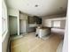 View of the kitchen with gray cabinets, island, and open layout to the living area at 15345 Burgtheater Dr, Winter Garden, FL 34787
