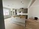 Spacious kitchen featuring gray cabinets, a large island, and white subway tile backsplash at 15345 Burgtheater Dr, Winter Garden, FL 34787