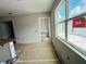 Living room under construction with large window, and doorway to additional living space and kitchen area at 15345 Burgtheater Dr, Winter Garden, FL 34787