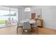 Dining room with a wood floor, a round table, and an art display, with a door to the backyard at 1536 Groveline Rd, St Cloud, FL 34771
