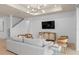 Bright living room featuring white walls, wood floors, recessed lighting, and a gray sofa with chairs at 1536 Groveline Rd, St Cloud, FL 34771