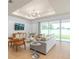 Modern living room with hardwood floors, a chic ceiling light, and a sliding glass door to the backyard at 1536 Groveline Rd, St Cloud, FL 34771