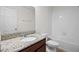 Bright bathroom featuring a granite countertop, modern faucet, and a tiled shower over a tub at 15477 Blackbead St, Winter Garden, FL 34787