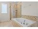 Luxury bathroom with a glass-enclosed shower and a luxurious soaking tub at 15477 Blackbead St, Winter Garden, FL 34787