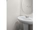Powder room features a pedestal sink and an oval mirror at 15477 Blackbead St, Winter Garden, FL 34787