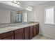 Elegant bathroom featuring double sinks, granite countertops, and a glass-enclosed shower at 15477 Blackbead St, Winter Garden, FL 34787