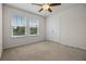 Bright bedroom with a ceiling fan, large windows and a double door closet at 15477 Blackbead St, Winter Garden, FL 34787
