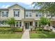Charming two-story townhome with manicured landscaping and a welcoming front porch at 15477 Blackbead St, Winter Garden, FL 34787