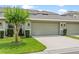 Charming home exterior featuring a well-maintained lawn, mature landscaping, and a two-car garage at 15477 Blackbead St, Winter Garden, FL 34787