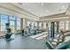 Bright gym with an array of cardio equipment, floor to ceiling windows and an open layout at 15477 Blackbead St, Winter Garden, FL 34787