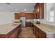 Well-equipped kitchen with stainless steel appliances, granite counters, and dark wood cabinetry at 15477 Blackbead St, Winter Garden, FL 34787