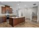 Spacious kitchen featuring dark cabinets, granite countertops, and an island with bar seating at 15477 Blackbead St, Winter Garden, FL 34787