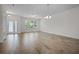Bright, spacious living room with tile floors and large windows providing natural light at 15477 Blackbead St, Winter Garden, FL 34787