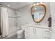 Well-lit bathroom with modern finishes, including a vanity, tub/shower, and unique mirror at 155 S Court Ave # 2406, Orlando, FL 32801