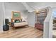 Bedroom featuring hardwood floors, unique accent wall, and a queen sized bed with decorative pillows at 155 S Court Ave # 2406, Orlando, FL 32801