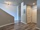 Hallway with hardwood floors, concrete pillar and accent walls at 155 S Court Ave # 2406, Orlando, FL 32801