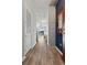 Hallway with hardwood floors, concrete pillar accent, leading into a living area with balcony access at 155 S Court Ave # 2406, Orlando, FL 32801