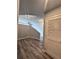 Hallway featuring gray laminate floors and exposed concrete ceiling with recessed lighting at 155 S Court Ave # 2406, Orlando, FL 32801