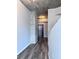 Hallway featuring gray laminate floors and exposed concrete ceiling and beam at 155 S Court Ave # 2406, Orlando, FL 32801