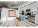 Modern kitchen with stainless appliances, tiled backsplash, and eat in dining area at 155 S Court Ave # 2406, Orlando, FL 32801
