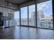 Contemporary kitchen, white cabinets, stainless appliances, modern backsplash, with a city skyline view at 155 S Court Ave # 2406, Orlando, FL 32801