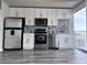 Kitchen features stainless steel appliances, white cabinets, gray backsplash and hardwood flooring at 155 S Court Ave # 2406, Orlando, FL 32801