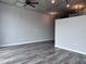 Open-concept living room with gray laminate floors, modern lighting, and exposed concrete ceiling at 155 S Court Ave # 2406, Orlando, FL 32801