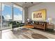 Inviting living room showcasing hardwood floors, modern furniture, and large windows with city views at 155 S Court Ave # 2406, Orlando, FL 32801