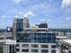 Amazing downtown skyline views from the building top with blue skies and fluffy clouds at 155 S Court Ave # 2406, Orlando, FL 32801