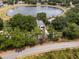 Overhead view of home with mature trees, providing privacy and a connection with nature at 1552 Whooping Dr, Groveland, FL 34736