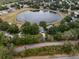 Aerial view of a lakeside home highlighting its beautiful surroundings and neighborhood amenities at 1552 Whooping Dr, Groveland, FL 34736