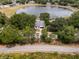 Aerial view of the home highlighting mature trees and landscaping at 1552 Whooping Dr, Groveland, FL 34736