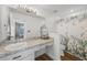 Bright bathroom featuring a large mirror, vanity, and shower with botanical-themed curtain at 1552 Whooping Dr, Groveland, FL 34736