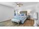 Bright bedroom featuring a decorative bed, ceiling fan, and wood-look flooring at 1552 Whooping Dr, Groveland, FL 34736