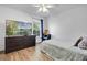 Bedroom featuring a TV, dresser, and wood-look flooring at 1552 Whooping Dr, Groveland, FL 34736
