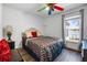 Bedroom featuring a patterned ceiling fan, lake view, and wood-look flooring at 1552 Whooping Dr, Groveland, FL 34736